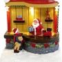 Beleuchtete Weihnachtsdorf Szene: Santa im Spielzeugladen mit Kind und Geschenken. Festliche Polyresin Dekoration.