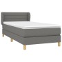 Dunkelgraues Boxspringbett 90x190 cm mit Matratze und Kopfteil aus Stoff.