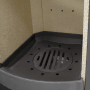 Detailaufnahme Brennraum mit Gussmulde und Rost des Thermia Kamin-Ofen München XL.