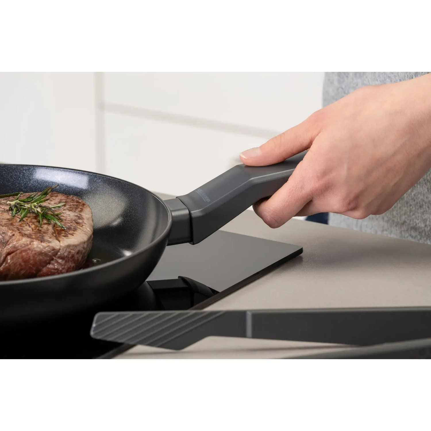 Fackelmann Bratpfanne Statement 24 cm mit Steak auf Induktionsherd.