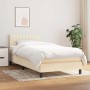 Cremefarbenes Boxspringbett 90x200 cm mit Matratze und Stoffbezug.