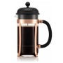 Bodum French Press Kaffeebereiter 1l mit elegantem Kupferrahmen, schwarzem Deckel und Griff, gefüllt.
