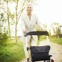 Frau nutzt Ridder Rollator Premium im Freien. Sport & Fitnessgerät mit Tasche und Rückengurt.