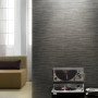 A.S. Création Vliestapete Best of Wood´n Stone Steinriemchen Grau an Wand mit Sofa und Plattenspieler.
