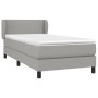 Helles Boxspringbett mit Matratze, 100x200 cm, grauer Stoff, mit Kopfteil.