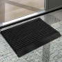 Schwarze Karat Fußmatte Power Brush 40x60 cm vor einer Tür. Fußabtreter mit Bürsten.