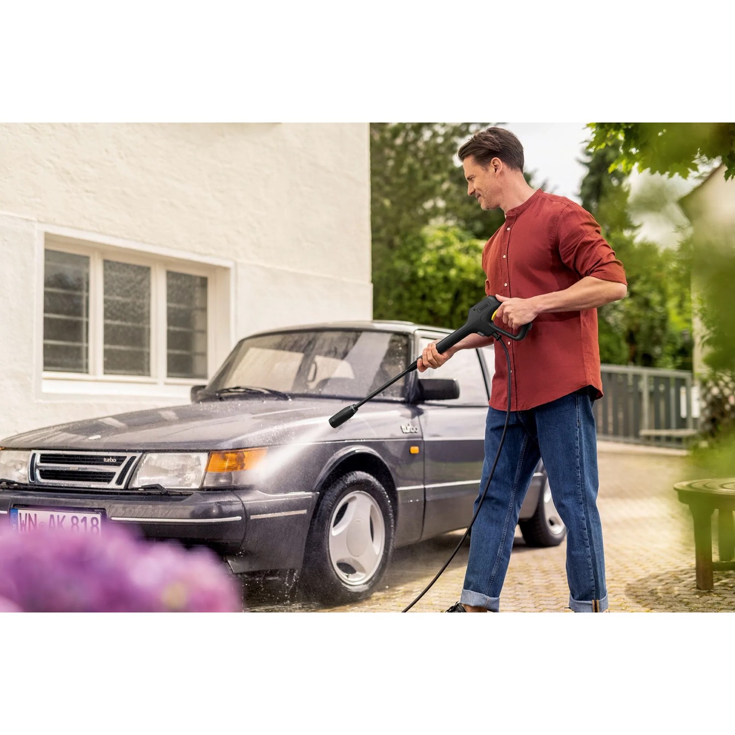 Mann reinigt Auto mit Kärcher Hochdruckreiniger K 3 Premium Car & Home. Inkl. Zubehör für Auto und Terrasse.