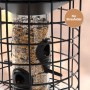 Schwarzes CULT at home Vogelfutterhaus aus Metall mit transparentem Futtersilo und Futterplätzen für Streufutter.