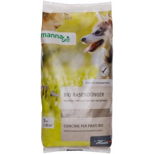 Manna Bio Rasendünger 5kg Sack mit Kind und Hund auf Wiese.