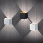 Drei LED Wandlampen Louis in Weiß und Schwarz an einer Betonwand mit Lichtkegeln.