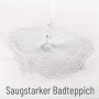 Wasser wird auf einen saugstarken, weißen Sanilo Badteppich gegossen.