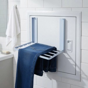 Weißer magnetischer Wäschetrockner aus Stahl, faltbar, mit Jeans in Badumgebung. Ideal für kleine Räume.