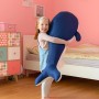 Mädchen umarmt blauen Westmann Pool Buddy Wal als Sitzsack oder Kuscheltier.
