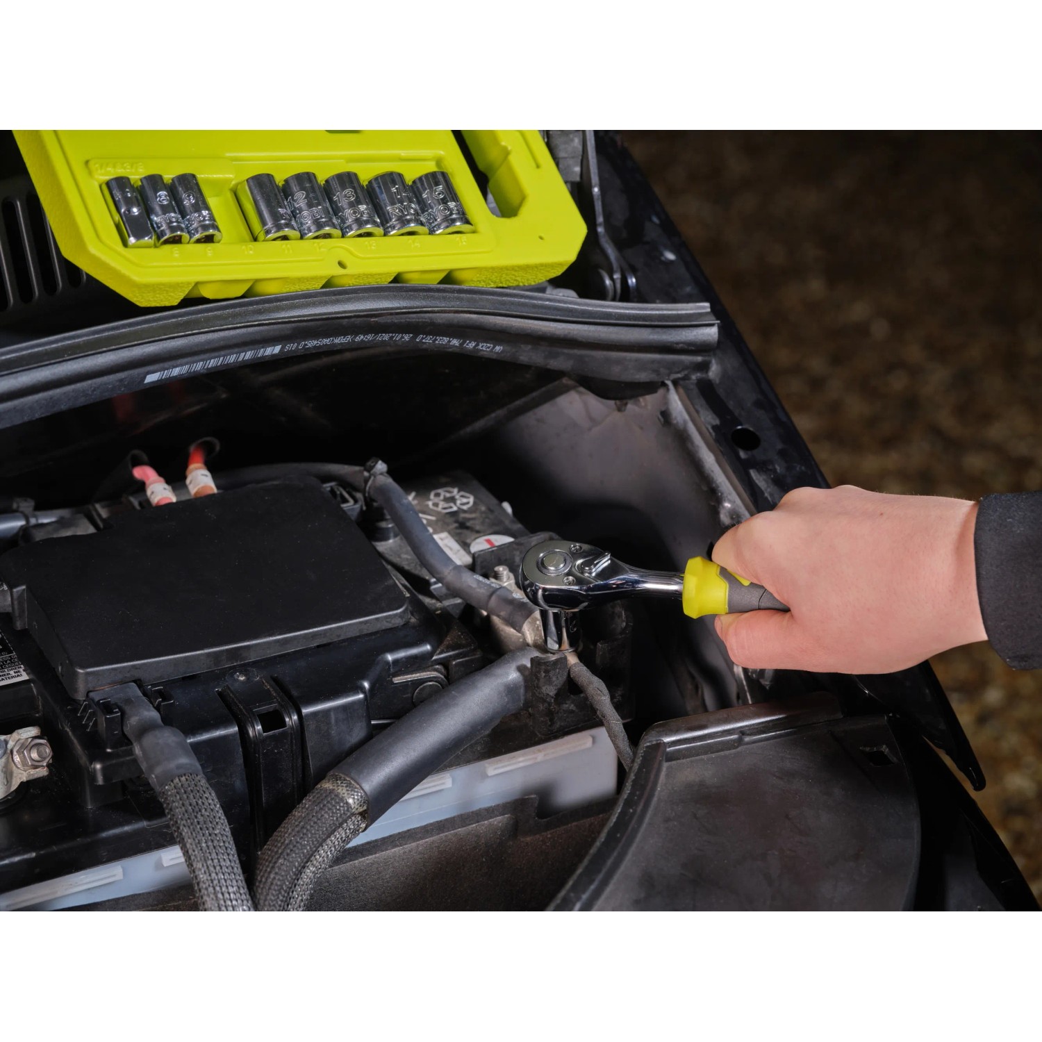 Ryobi Steckschlüssel-Set RHRS10PC im Einsatz am Auto, 9-teilig mit Ratsche und Nüssen in Transportbox.