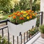 Weißer Relaxdays Balkonkasten in Rattan-Optik mit Halterung, selbstbewässernd, Füllstandsanzeige, gefüllt mit Blumen.