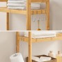 Vasagle Toilettenregal aus Bambus mit Handtüchern, Toilettenpapier und Badutensilien.