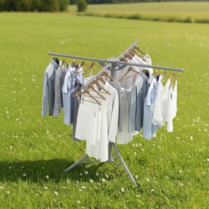Grauer klappbarer Wäscheständer aus Stahl und Kunststoff mit Kleidung auf Kleiderbügeln im grünen Garten. Perfekt zum Trocknen.