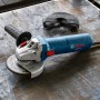 Bosch Professional GWS 12-125 Winkelschleifer mit Zubehör auf Werkbank.