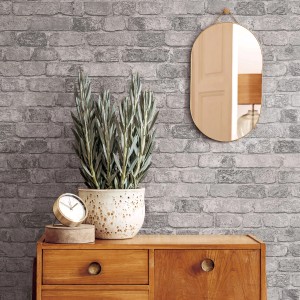 Marburg Vliestapete Imagine in Grau mit Stein- und Holzoptik an einer Wand im Wohnraum.