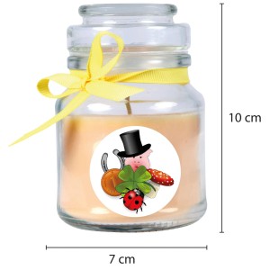 Gelbe Duftkerze im Glas mit Glückssymbolen und Vanilleduft.