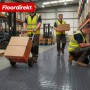 Dunkelgrauer PVC-Bodenbelag Check Quadra mit Quadratmuster in Lagerhalle.
