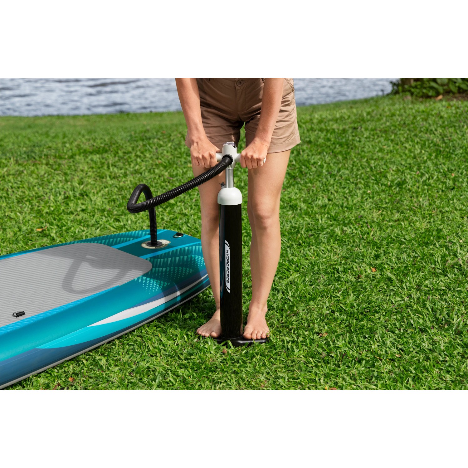 Frau pumpt Bestway SUP Board mit Pumpe auf. Stand Up Paddle Zubehör.
