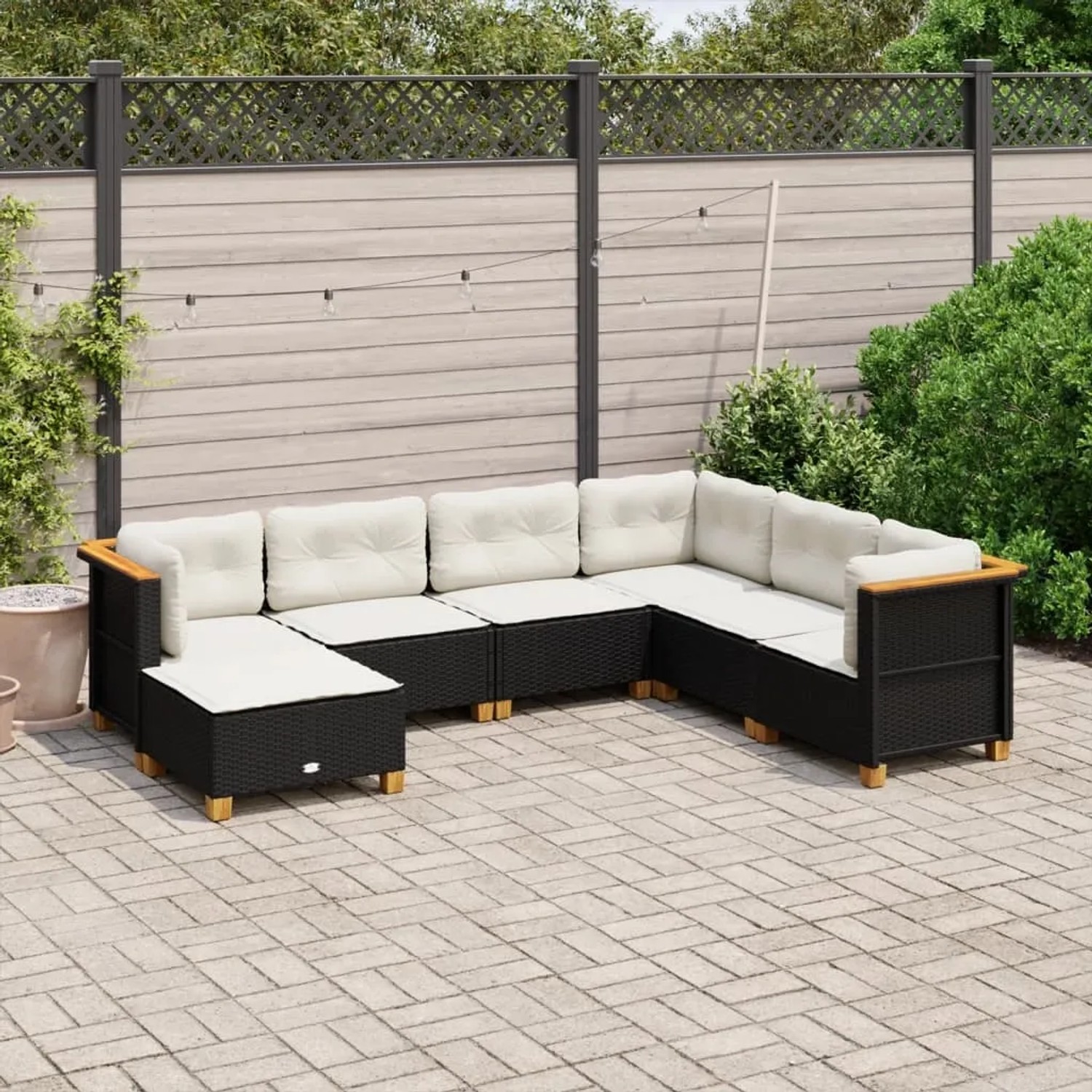 Schwarze 7-tlg. vidaXL Garten-Sofagarnitur aus Rattan mit cremeweißen Kissen.