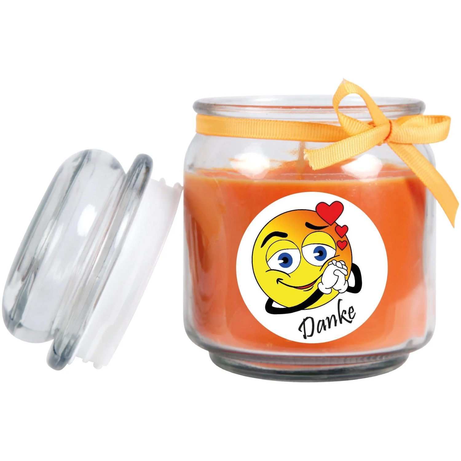 Orange Duftkerze im Glas mit Danke-Emoji und Schleife, Deckel geöffnet.
