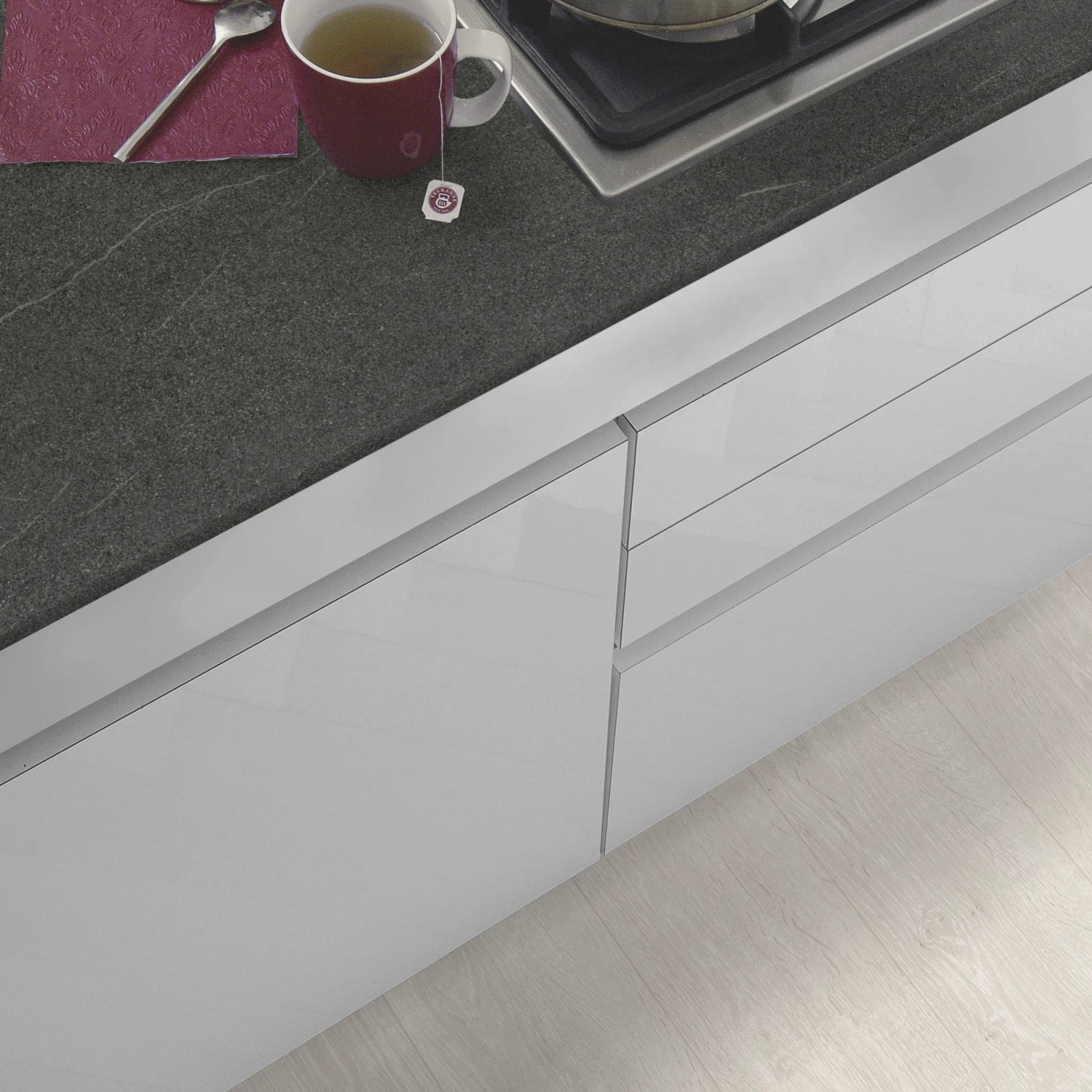 Kaindl Arbeitsplatte Torreano Anthrazit, 260x60x2,8 cm, mit Tasse und Kochfeld, Detailansicht.