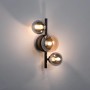 Schwarze Paul Neuhaus Wandlampe Popsicle mit drei Amber- und Rauchglas-Kugeln.