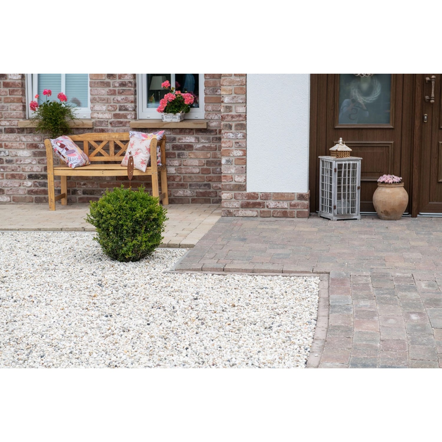 Verlegtes Diephaus Pflasterstein Collo Herbstlaub, 14x14x7 cm, im Außenbereich mit Bank und Dekoration.