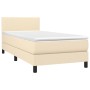 Cremefarbenes Boxspringbett 90x190 cm mit Matratze und Kopfteil.