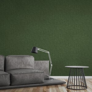 Dunkelgrüne A.S. Création Vliestapete Greenery Uni meliert an Wand im Wohnraum.