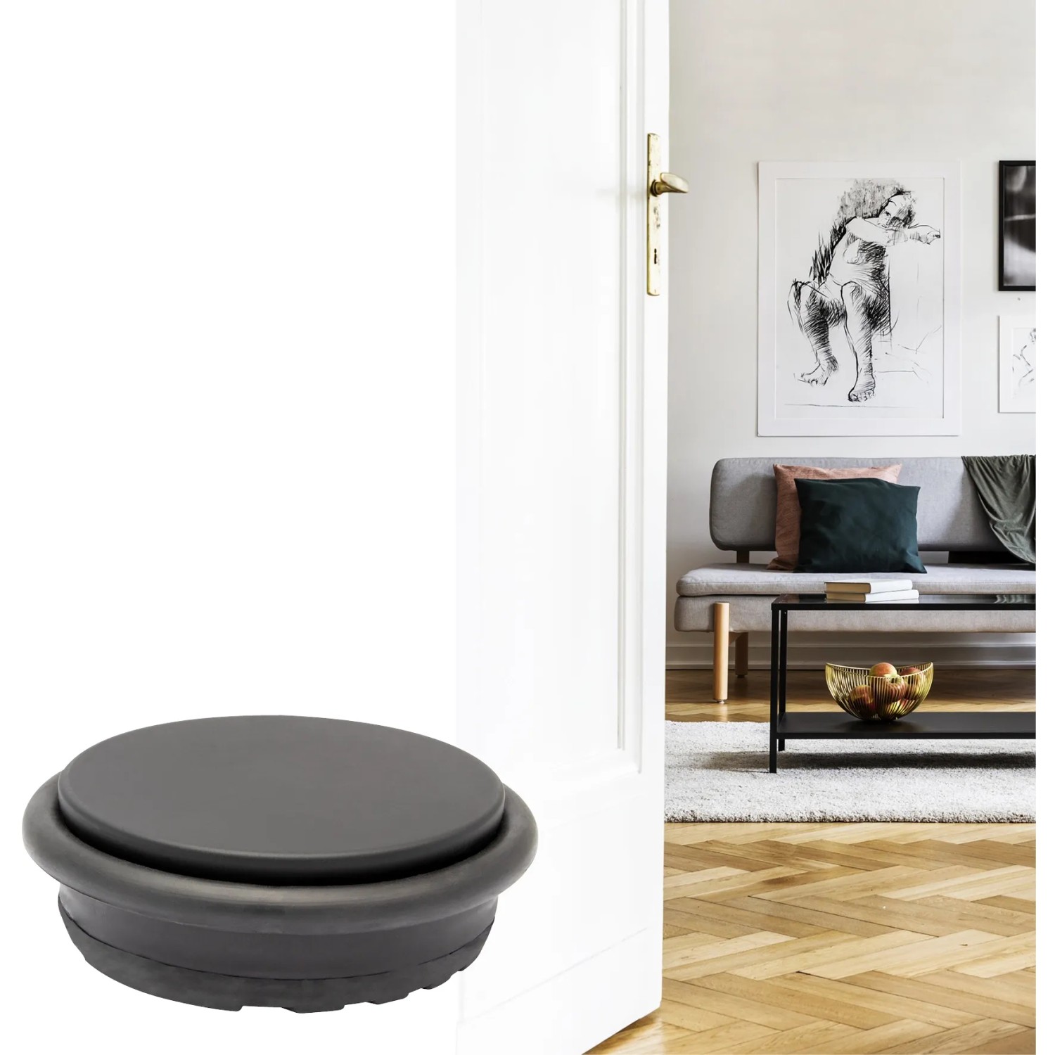 Schwarzer, runder Wagner Bodentürstopper Big Disk Color aus Stahl vor weißer Tür.