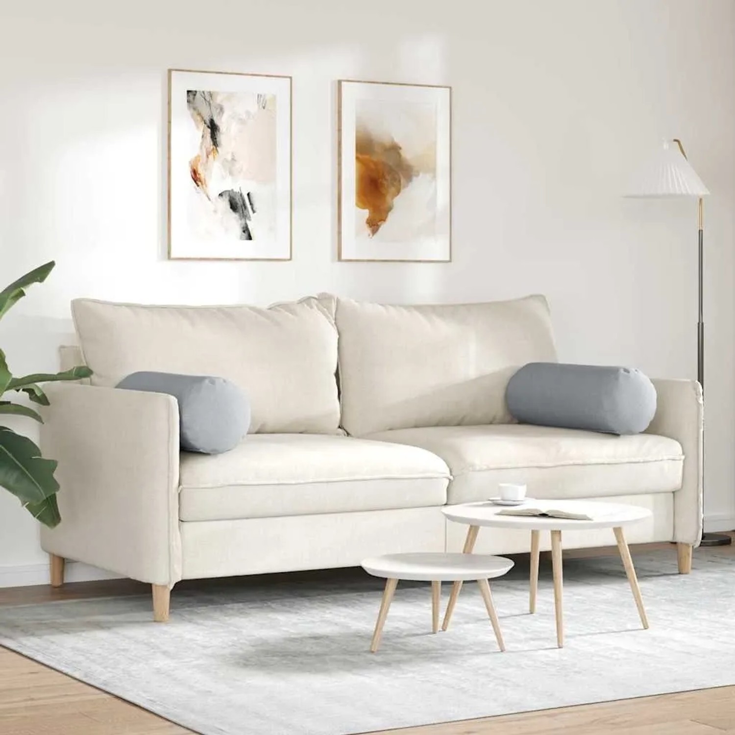 Zwei hellgraue vidaXL Bolsterkissen (Ø 25x70 cm) aus Stoff auf einem Sofa.