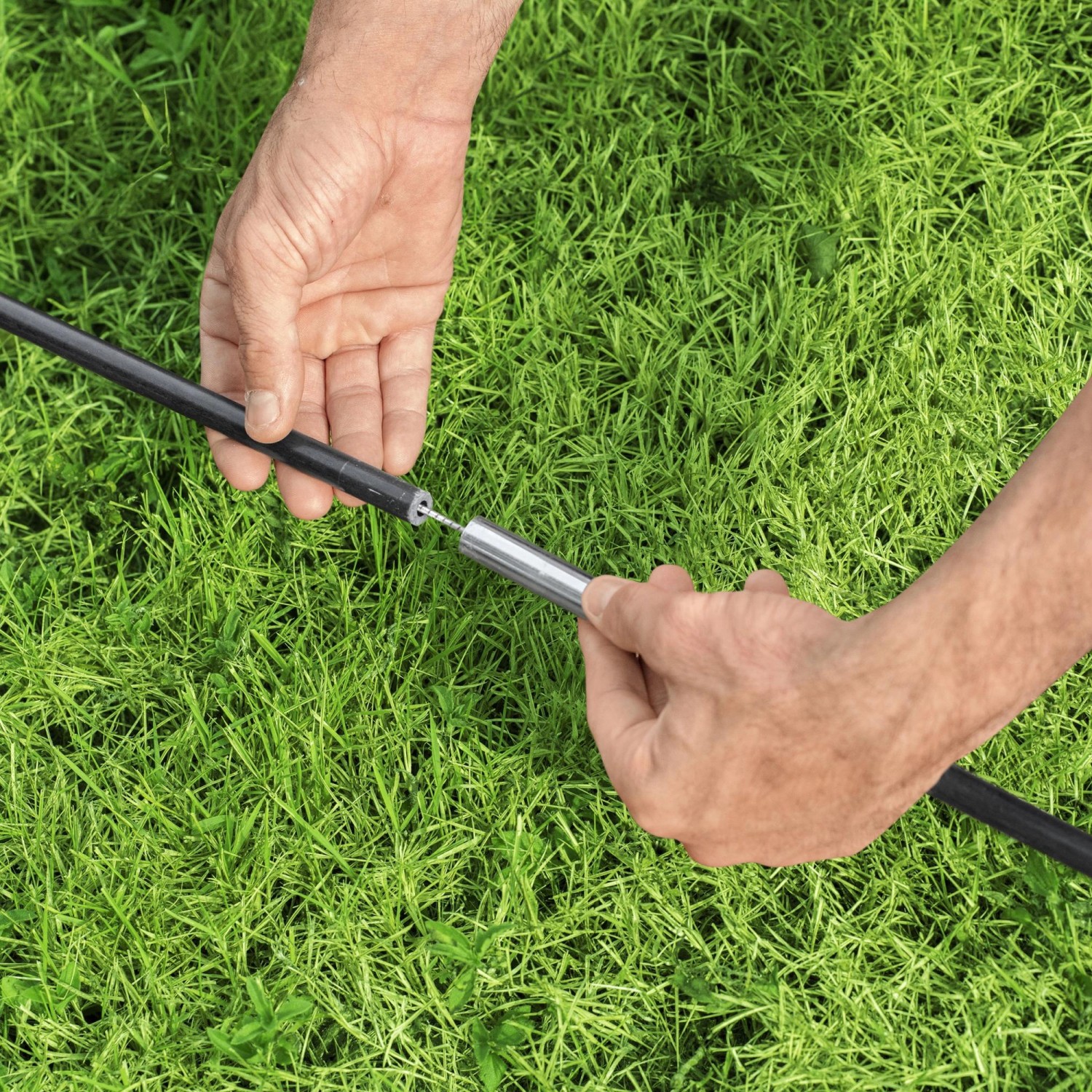 Aufbau des Bestway Lay-Z-Spa Pavillons: Eine Person verbindet die Stangen des Poolzelts.