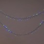 OBI Außen-Lichterkette, 400 Multicolor LEDs (blau, grün) auf grünem Kabel, dekorativ drapiert.