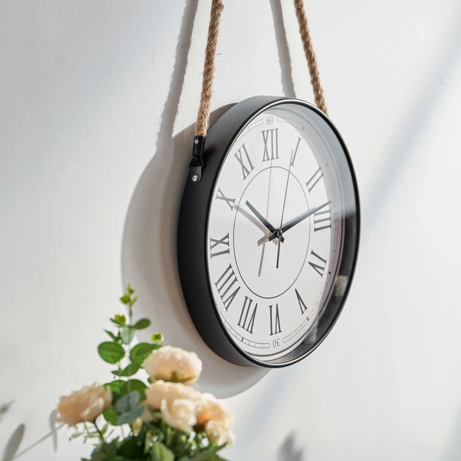 Schwarze Wanduhr Ø 35cm mit weißem Zifferblatt, römischen Ziffern und Sisalkordel. Lautloses Uhrwerk aus Kunststoff.