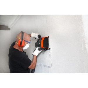 Mann mit Boels Sicherheitsset (Brille, Maske, Gehörschutz, Handschuhe) bei der Arbeit.