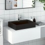 Rechteckiges, mattschwarzes vidaXL Waschbecken aus Mineralguss auf einem weißen Waschtisch.