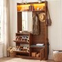 Kompakte Garderobe in Nussbaum Optik mit Spiegel, Schuhschrank, Sitzbank und LED-Beleuchtung für den Flur.