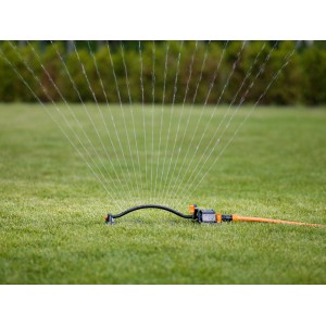 Fiskars Oszillierender Sprinkler bewässert Rasenfläche, Reichweite einstellbar.