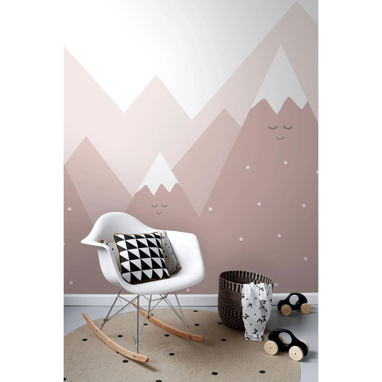 Sanders Fototapete Berge altrosa im Kinderzimmer mit Schaukelstuhl und Spielzeug.