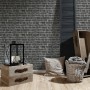 A.S. Création Vliestapete Best of Wood´n Stone Klinkerstein Schwarz, Detailaufnahme einer Wohnraum Szene.