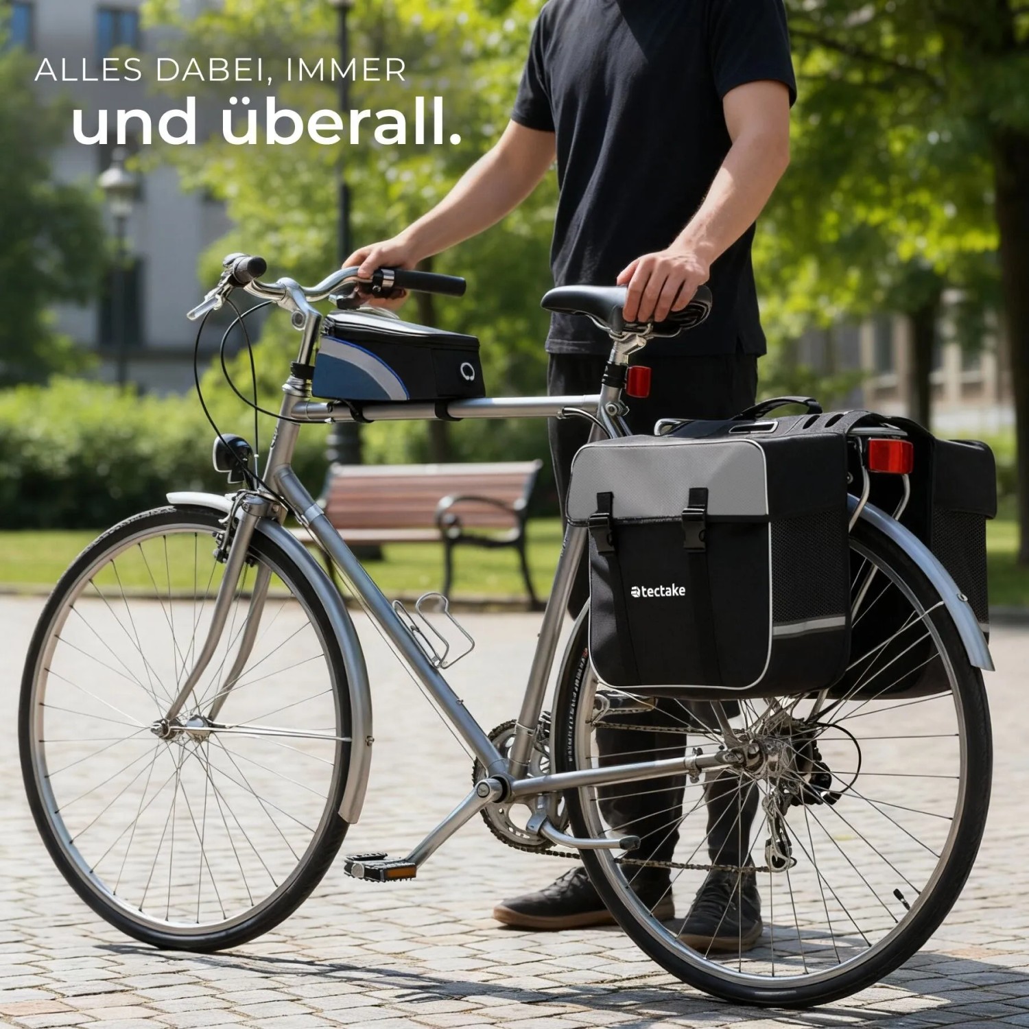 Fahrrad mit Tectake Fahrradtaschen Set (Gepäckträger- und Rahmentasche) für Radtouren.