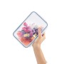 Rotho Kühlschrankdose Clic & Lock Glas, 1,3 l, mit Obstsalat in Hand gehalten.