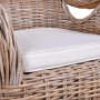 Braungrauer Rattan Sessel mit heller Sitzauflage, geflochtene Struktur, für gemütliche Stunden.
