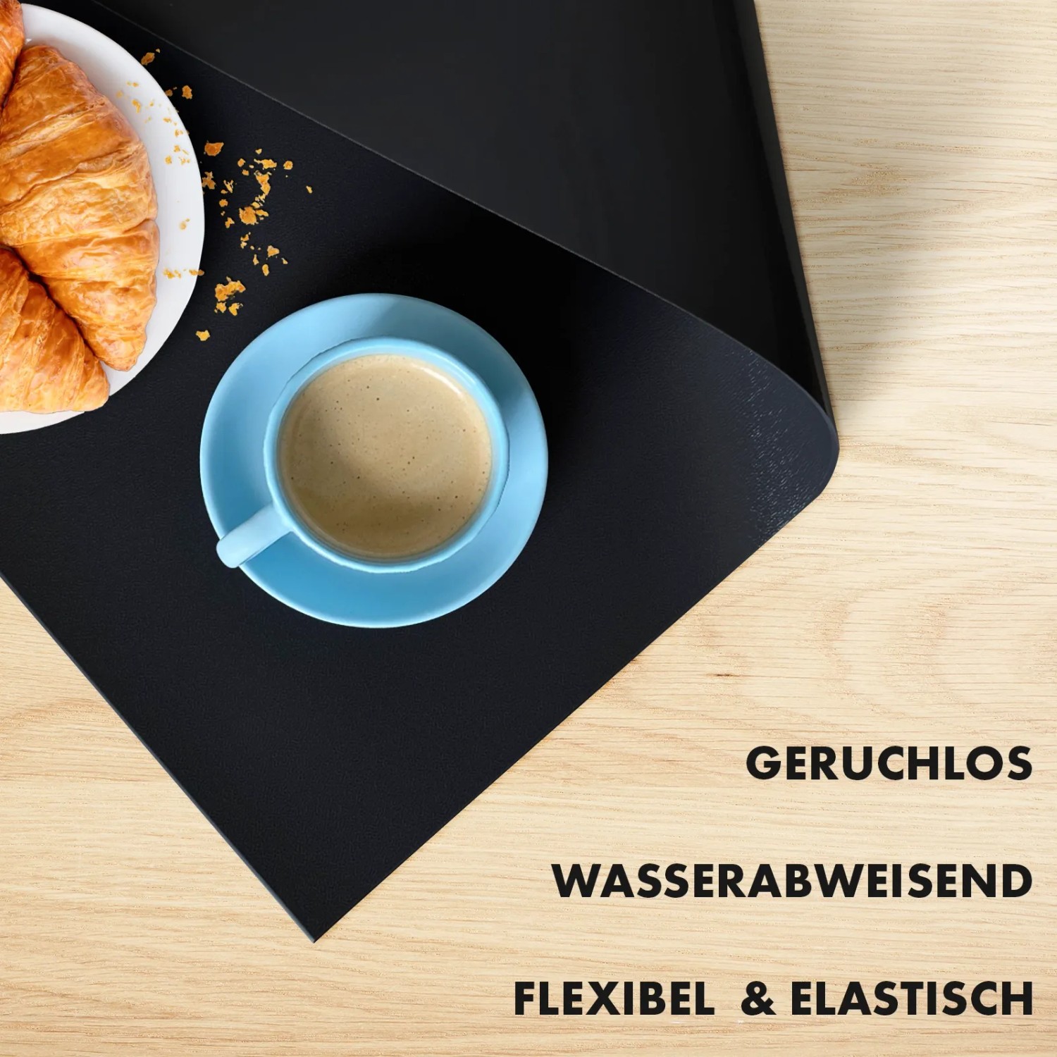 Schwarze KARAT Tischfolie Empire mit Kaffee und Croissants. Tischdecke mit abgeschrägter Kante.