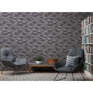 A.S. Création Vliestapete in dunklem Grau mit Ziegelsteinoptik im Wohnraum.