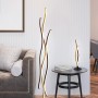 Moderne Trio LED Stehleuchte Blaze, 1-flammig, Messing matt und Design-Tischleuchte auf Beistelltisch.